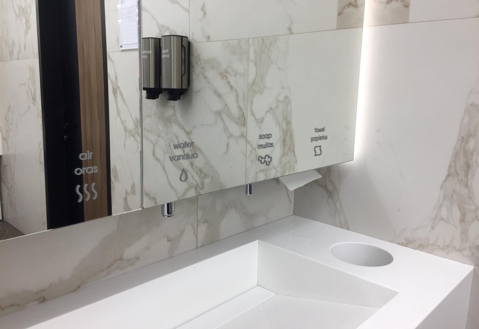 Behind the Mirror touch-free faucets, automatic soap dispensers, high-speed hand dryers and paper towel dispensers